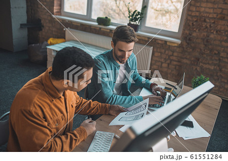 Top view of smart young men working in team Top view of smart young men working in team 61551284