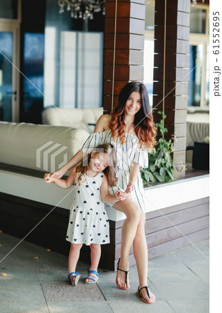 Mom walking in summer with little daughter. 61552695