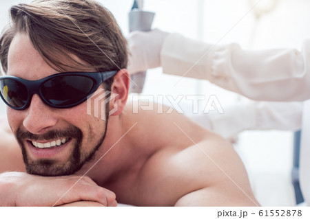 Man in a hair removal studio 61552878