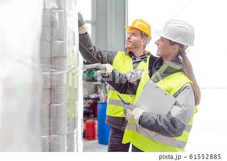 Workers in the rental toilet business checking the paper stock 61552885