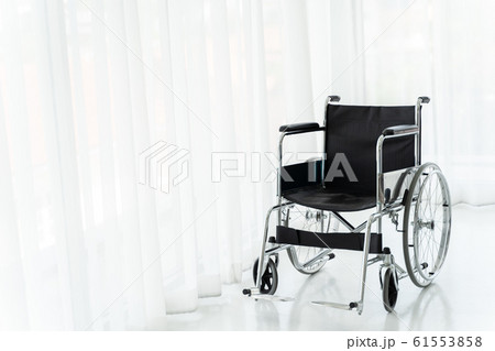 Empty wheelchair in hospital ward 61553858