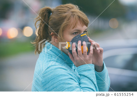 Woman wearing a real anti-pollution, anti-smog and 61555254
