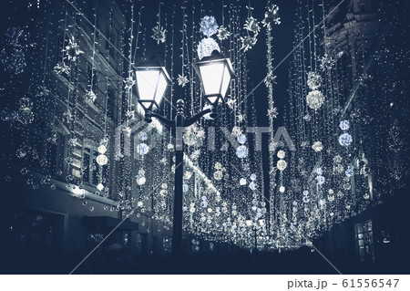 Abstract monochromatic Christmas street with illumination, burning lantern closeup, Christmastide, modern background, fashion color 61556547