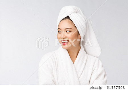 Portrait of a young happy asian lady in bathrobe.Isolated in white background. 61557508