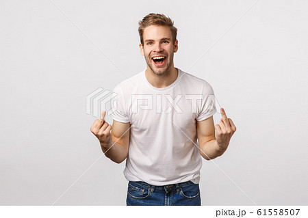 Rude and expressive, intollerant blond happy careless guy, dont care people opinion, fuck-off, showing middle fingers and cursing with smile on face, feeling daring and sassy, white background 61558507