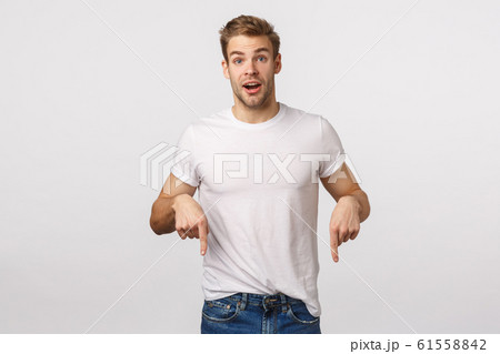 Excited, charistmastic surprised happy blond male model with bristle, pointing down joyful, sharing good news, introduce product, recommend download app, click link or banner, white background Excited, charistmastic surprised happy blond male model with bristle, pointing down joyful, sharing good news, introduce product, recommend download app, click link or banner, white background 61558842