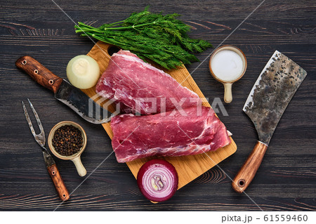 Overhead view of raw pork fillet on cutting board Overhead view of raw pork fillet on cutting board 61559460