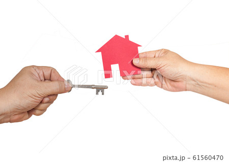 Red house in hand with house key on background. 61560470