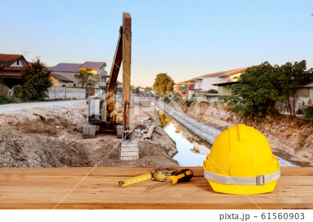 yellow construction safety helmet on wood yellow construction safety helmet on wood 61560903