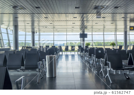 Modern airport waiting hall interior with empty chairs. Modern airport waiting hall interior with empty chairs. 61562747