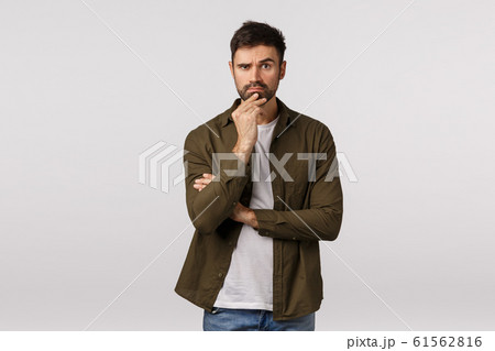Thoughtful, serious smart bearded man listen friend demand trying solve problem, standing pensive, making difficult choice, touching chin, raise eyebrow hesitant, have doubts as thinking Thoughtful, serious smart bearded man listen friend demand trying solve problem, standing pensive, making difficult choice, touching chin, raise eyebrow hesitant, have doubts as thinking 61562816