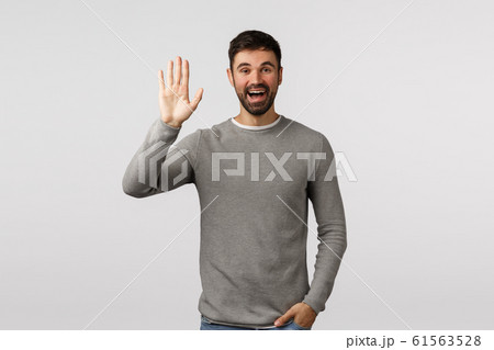 Friendly, cheerful and outgoing smiling bearded caucasian man, greeting neighbour raising arm and waving in hello, hi gesture, see person as waiting in meeting spot, standing white background Friendly, cheerful and outgoing smiling bearded caucasian man, greeting neighbour raising arm and waving in hello, hi gesture, see person as waiting in meeting spot, standing white background 61563528