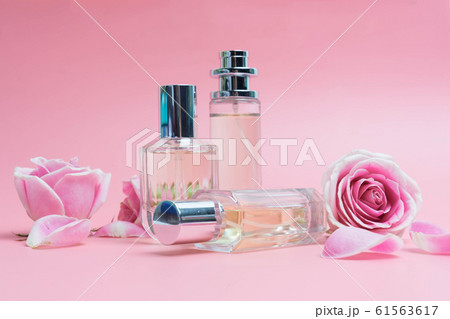 Perfume bottles on pink background Perfume bottles on pink background 61563617