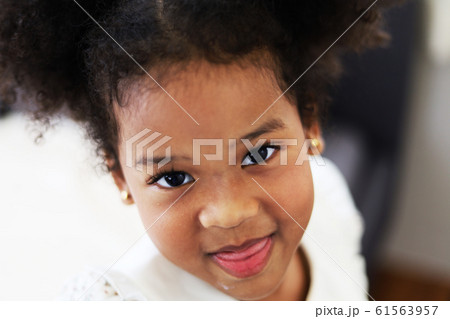 Beautiful African american girl kid smile portrait in home. 61563957