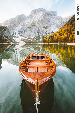 Traditional rowing boat on alpine lake in fall 61564697