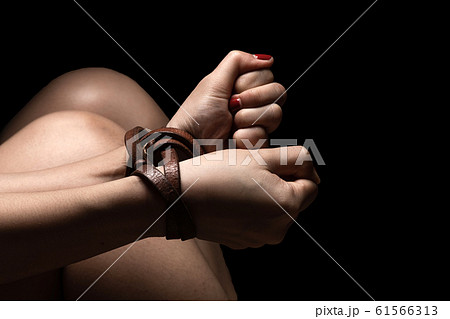 Woman tied up with leather belt in emotional 61566313