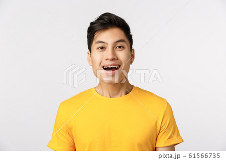 Close-up studio shot, amused cute asian guy smiling as seeing something wonderful, look enthusiastic and impressed, attend beautiful interesting performance, standing entertained white background Close-up studio shot, amused cute asian guy smiling as seeing something wonderful, look enthusiastic and impressed, attend beautiful interesting performance, standing entertained white background 61566735