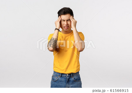 Depressed, dizzy young asian male student tired, trying remember something slipped his mind, rub temples, frowning and grimacing from pain, having migraine, huge headache, white background Depressed, dizzy young asian male student tired, trying remember something slipped his mind, rub temples, frowning and grimacing from pain, having migraine, huge headache, white background 61566915