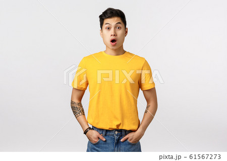Surprised, speechless very impressed asian cute young guy in yellow t-shirt, gasping, drop jaw from amazement, stare astonished without words looking at incredible promo banner, white background Surprised, speechless very impressed asian cute young guy in yellow t-shirt, gasping, drop jaw from amazement, stare astonished without words looking at incredible promo banner, white background 61567273