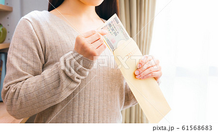 封筒からお札を出す女性　16:9 61568683
