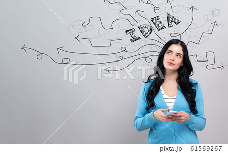 Brainstorming idea arrows with woman holding a smartphone 61569267