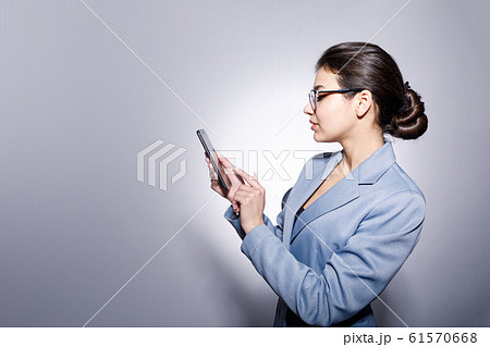 Sideview Portrait of Attractive Young Businesswoman Using Smartphone Sideview Portrait of Attractive Young Businesswoman Using Smartphone 61570668