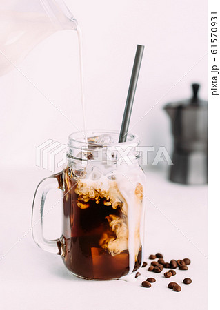 Iced coffee drink on glass jar with straw. Iced coffee drink on glass jar with straw. 61570931