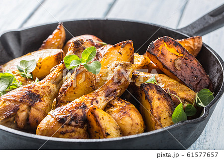 Roasted chicken legs in pan with american potatoes Roasted chicken legs in pan with american potatoes 61577657