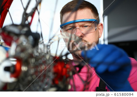 Man in protective gloves and eyewear 61580094
