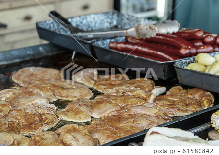 buffet assortment of dishes a piece of raw chicken buffet assortment of dishes a piece of raw chicken 61580842