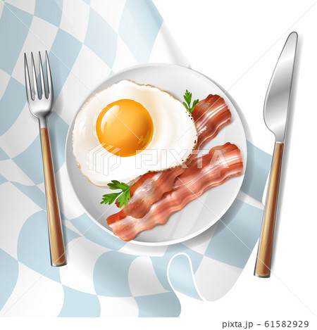 fried eggs with bacon strips and parsley 61582929