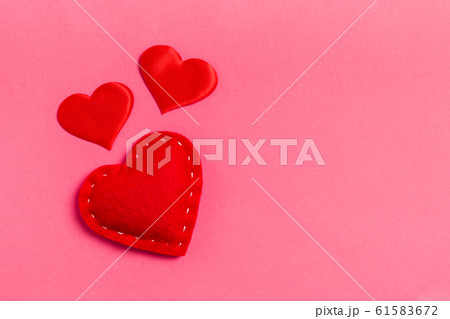 Top view of red textile hearts on colorful 61583672