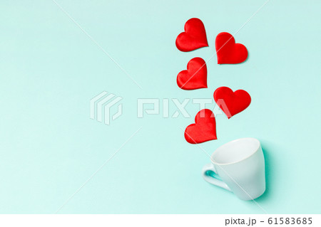 Top view of red textile hearts splashing out of a Top view of red textile hearts splashing out of a 61583685