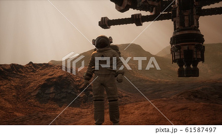 Spaceman walks on the red planet Mars. Space Spaceman walks on the red planet Mars. Space 61587497