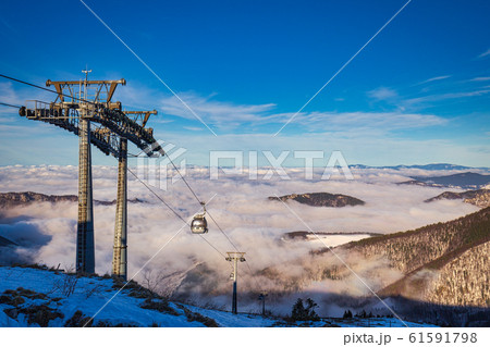 Winter mountain landscape at a sunny day with fog Winter mountain landscape at a sunny day with fog 61591798