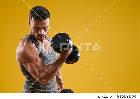 Strong brutal bodybuilder lifting heavy weight 61593904