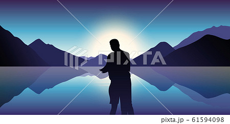 couple in love enjoy the blue mountain and ocean landscape in the dusk couple in love enjoy the blue mountain and ocean landscape in the dusk 61594098