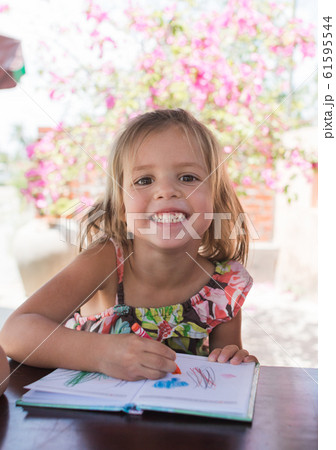 Adorable little girl drawing artwork top view on 61595544
