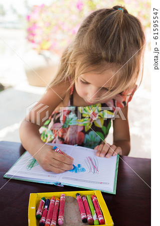 Adorable little girl drawing artwork top view on 61595547
