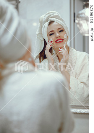 Beautiful woman standing in a bathroom Beautiful woman standing in a bathroom 61596876