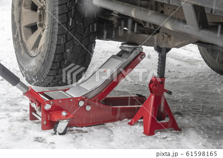 Car lifted on hydraulic Jack and Jack stand.  61598165