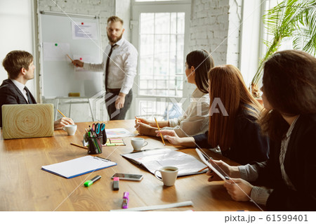 Group of young business professionals having a meeting, creative office Group of young business professionals having a meeting, creative office 61599401