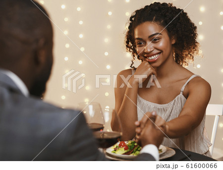 Close up of pretty black woman having date at restaurant 61600066