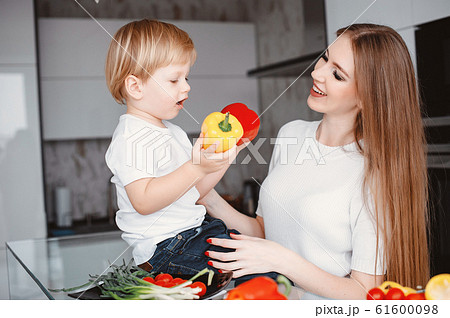 Family prepare the salad in a kitchen Family prepare the salad in a kitchen 61600098