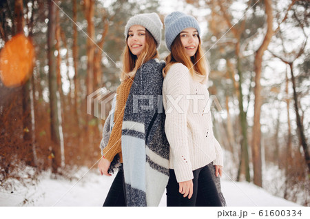 Two cute girls in a winter park 61600334