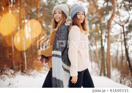 Two cute girls in a winter park Two cute girls in a winter park 61600335