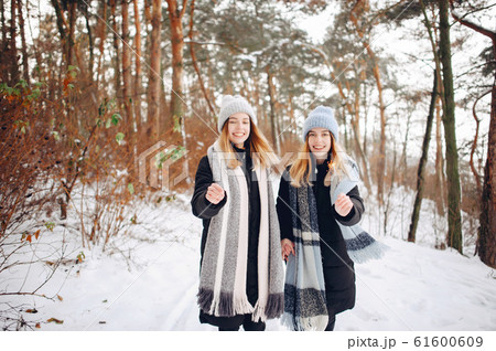 Two cute girls in a winter park Two cute girls in a winter park 61600609
