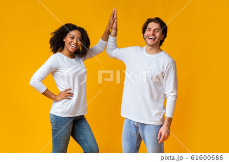 Joyful Afro Girl And White Guy Giving Figh-Five To Each Other 61600686