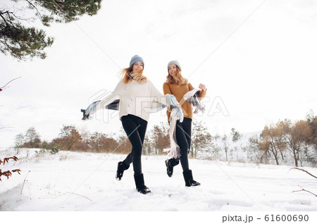 Two cute girls in a winter park 61600690