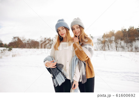 Two cute girls in a winter park 61600692